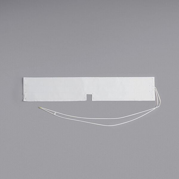 A rectangular white blanket with a wire attached to it.