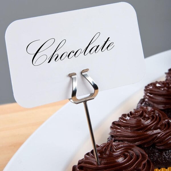 A plate of chocolate cupcakes with Ateco label holders on a sign.