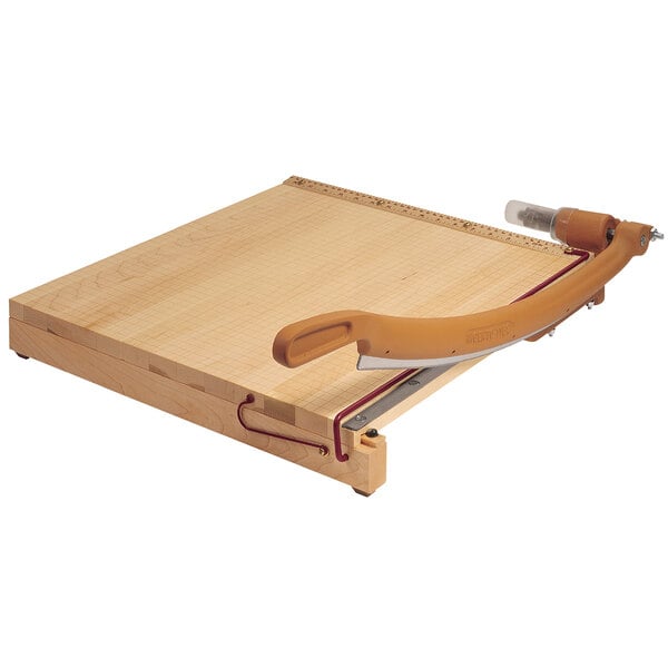 A Swingline Ingento paper trimmer with a wooden cutting board and metal blade.
