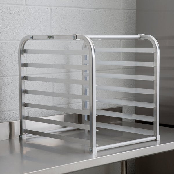 A Regency unassembled metal countertop sheet pan rack with metal bars.