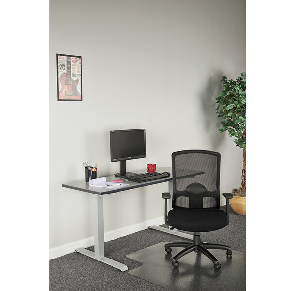 A black desk with a black Alera Etros Series mesh high-back chair and a computer on it.