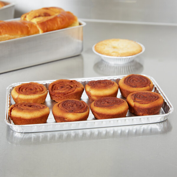 A Durable Packaging foil Danish pan filled with cinnamon rolls on a counter.
