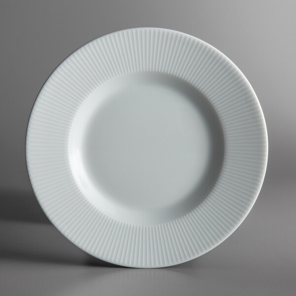 A Schonwald Continental white porcelain plate with a thin ribbed rim.
