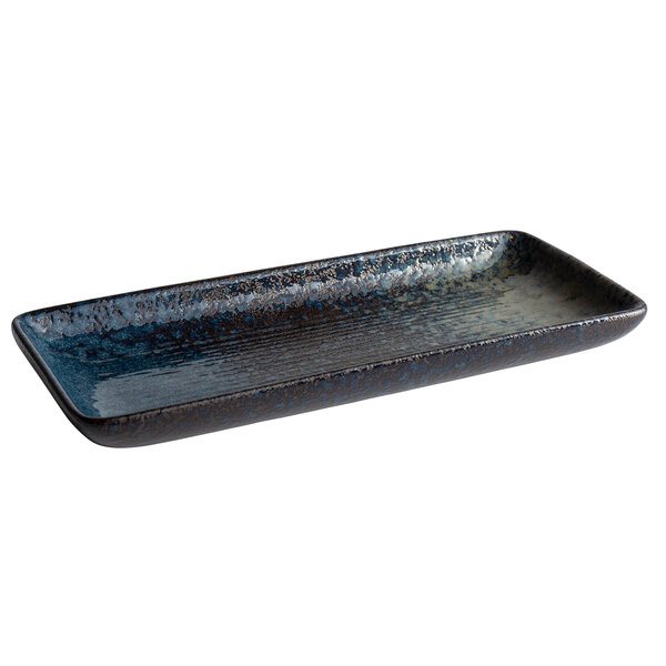 A rectangular stoneware platter with a dark blue glaze with speckled specks.