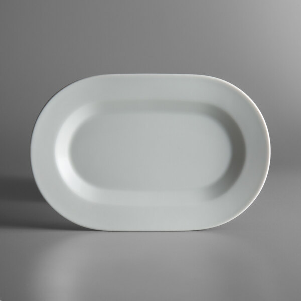 A white Schonwald oval platter with a black border on a gray surface.