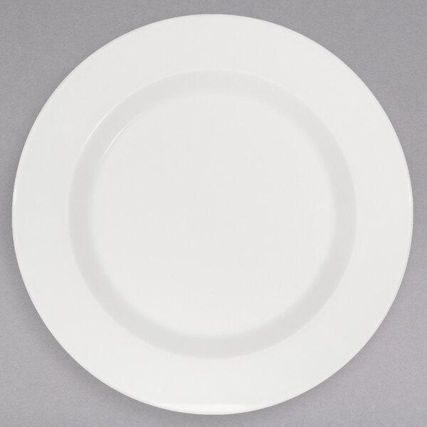 A Schonwald white porcelain plate with a white rim on a gray background.