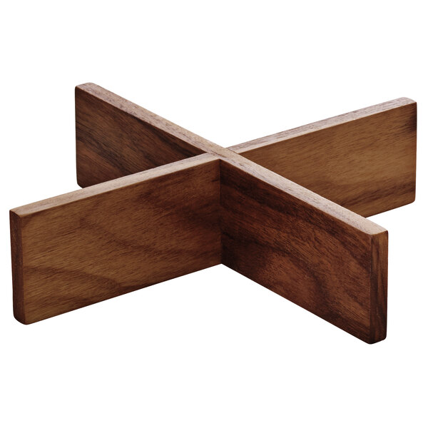 A Playground Ananti walnut wood square tray stand insert with a wooden cross-shaped object.