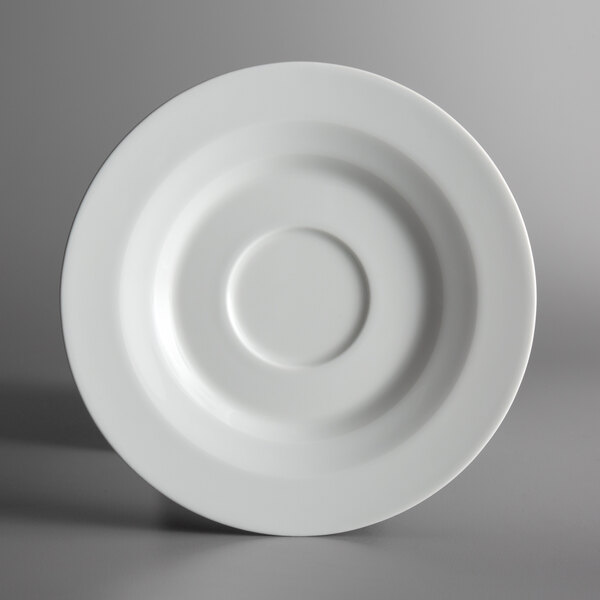 A Schonwald bone white porcelain saucer with a circle in the middle.