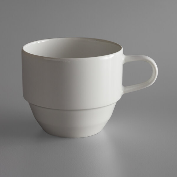A Schonwald Allure bone white porcelain tea cup with a handle on a gray surface.