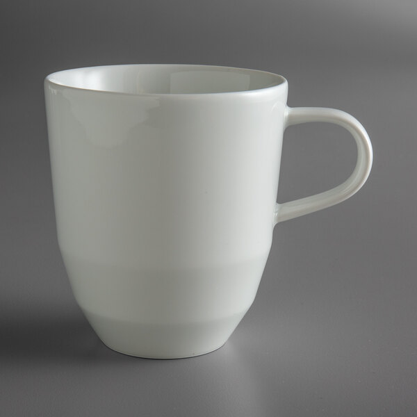 A Schonwald bone white porcelain coffee mug with a handle.