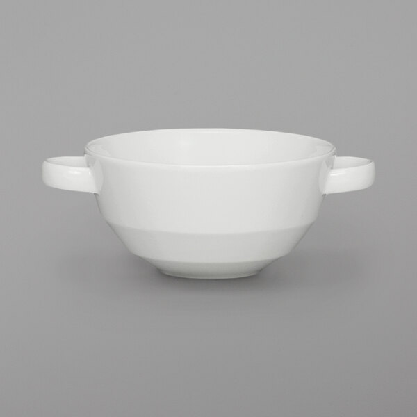 A Schonwald bone white porcelain bouillon bowl with two handles on a gray surface.