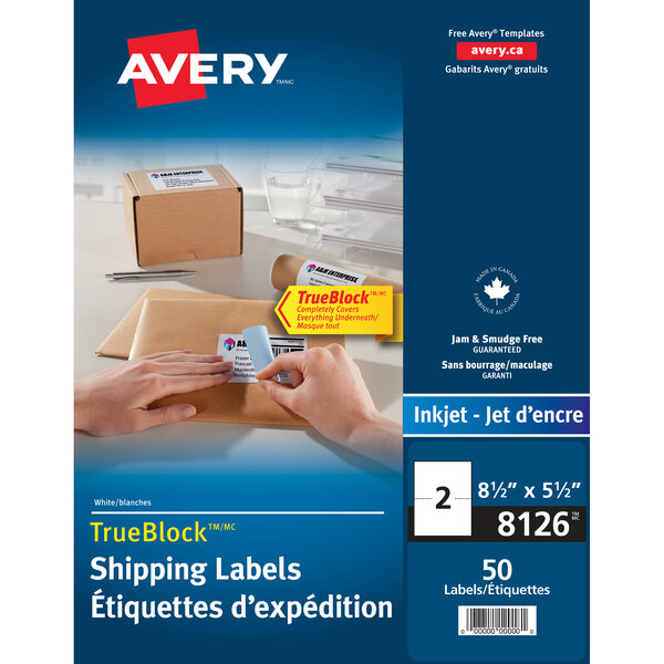 A person's hand holding a white Avery shipping label.