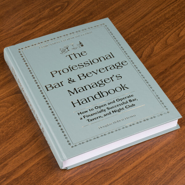 The Professional Bar and Beverage Manager's Handbook on a table in a bar.