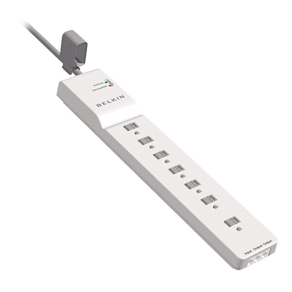 A close-up of a white Belkin surge protector with 7 outlets.