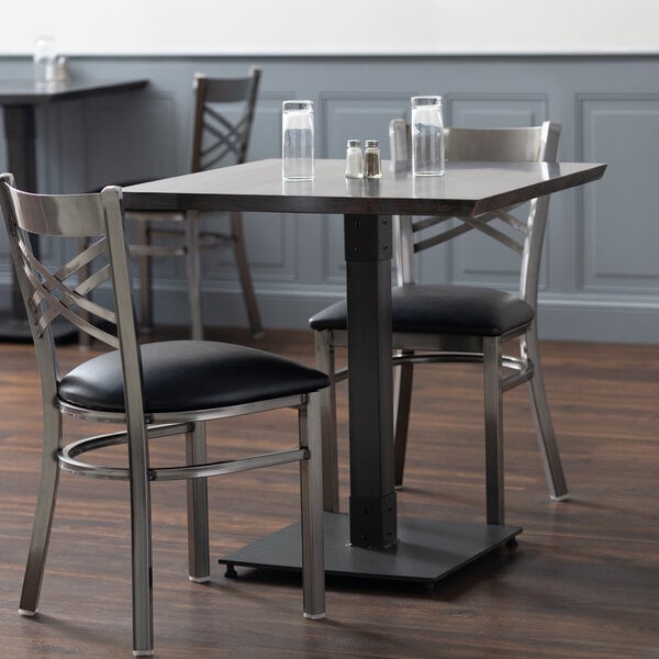 A Lancaster Table & Seating live edge wood table and chairs in a restaurant dining area.