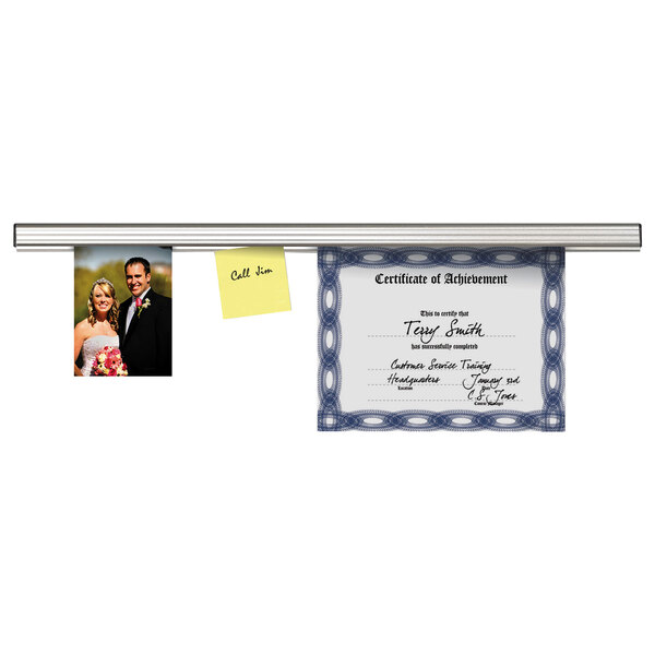 A certificate and a picture of a couple displayed on an Advantus aluminum grip-a-strip.