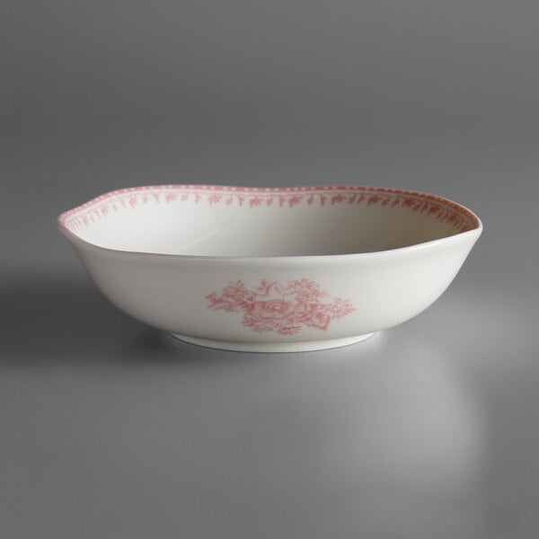 A white porcelain bowl with pink flower designs.