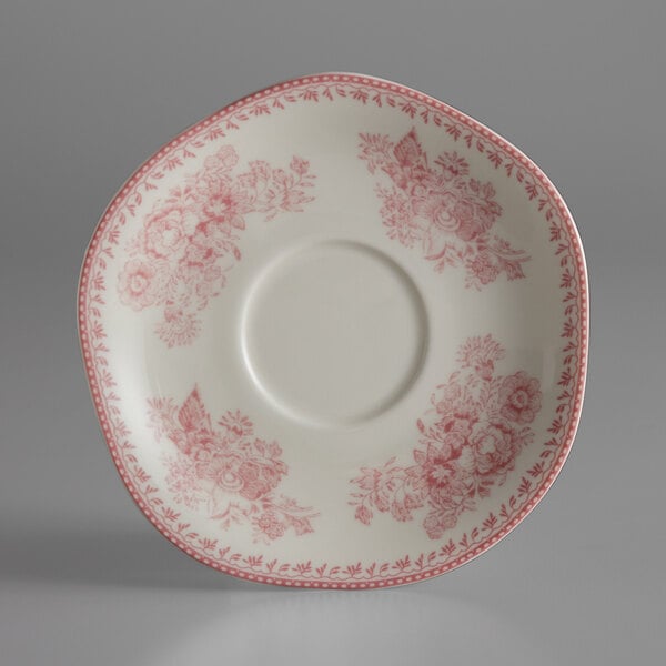 A white Oneida Lancaster Garden porcelain saucer with a pink and red floral design.