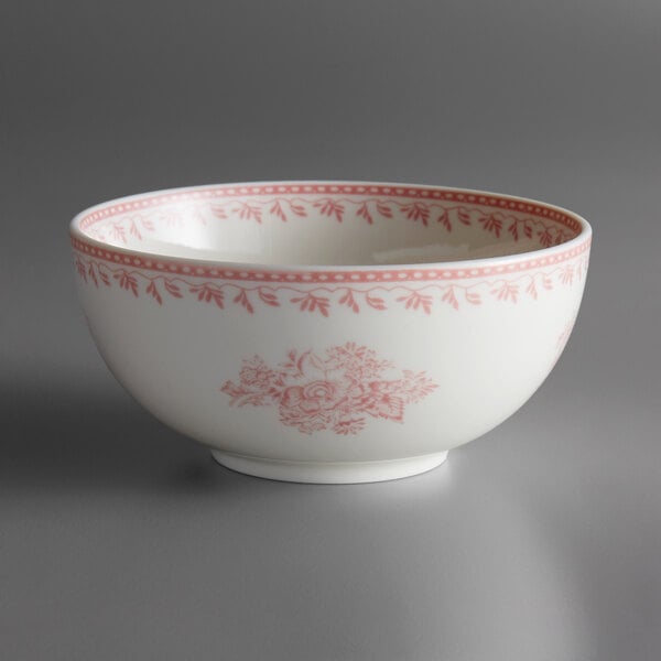 A white porcelain Oneida Lancaster Garden bowl with pink designs on it.