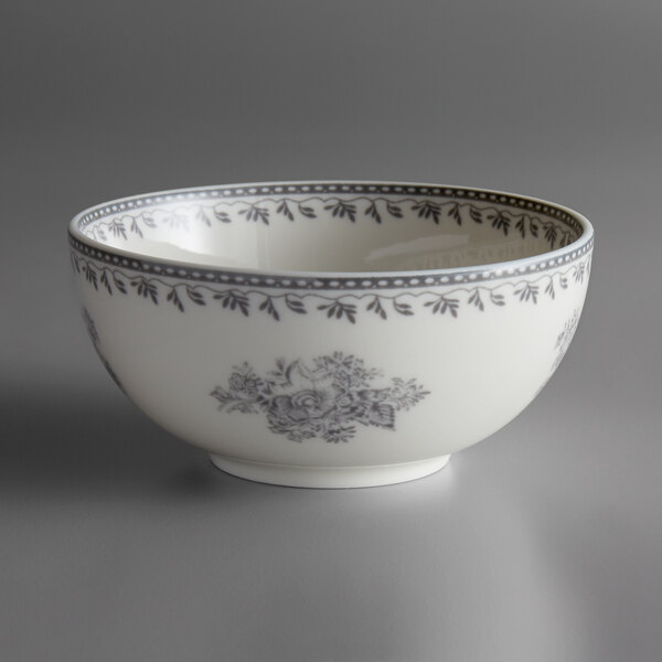 A white Oneida Lancaster Garden porcelain bowl with a blurry floral design.