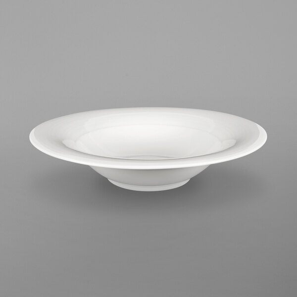An Oneida Chord white porcelain pasta bowl with a rim on a white background.