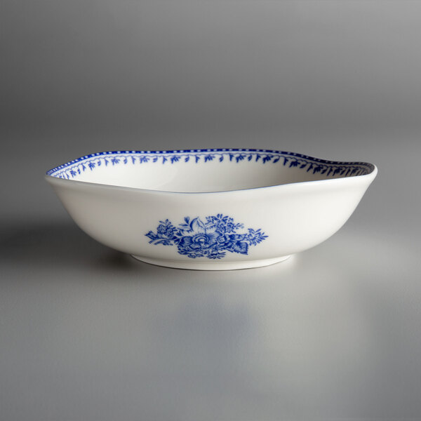 A white Oneida porcelain bowl with a blue floral design.