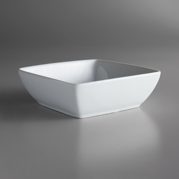 A white porcelain square bowl with a silver rim.