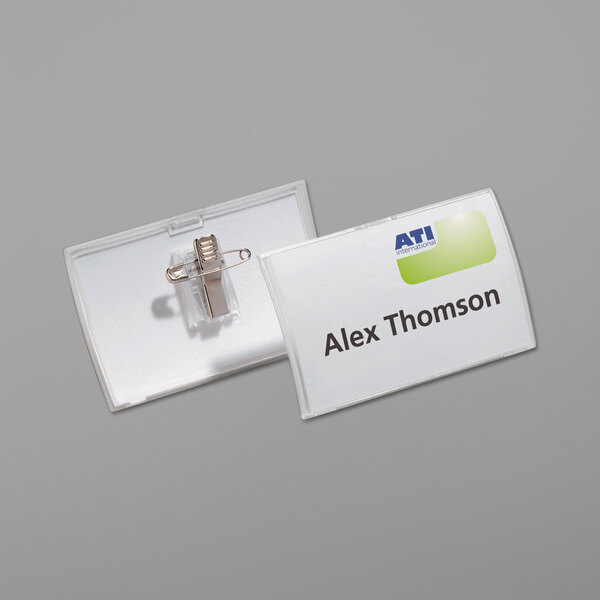 A clear polypropylene name tag with a combi-clip attached.