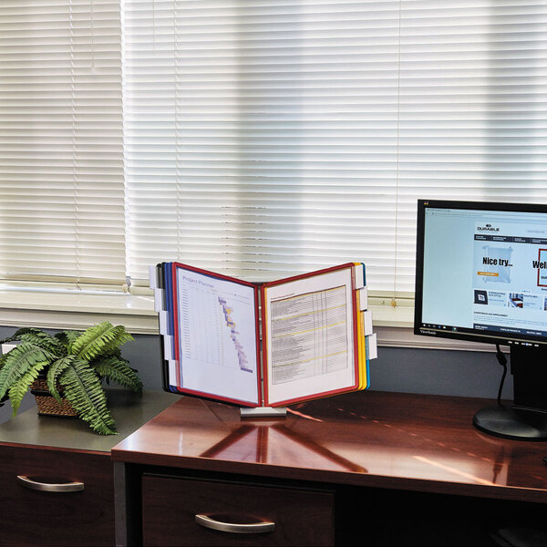 A Durable expandable desktop reference system with a computer and monitor on the desk.