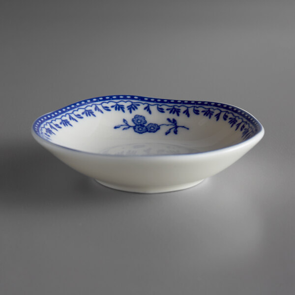 A white bowl with blue designs on it.