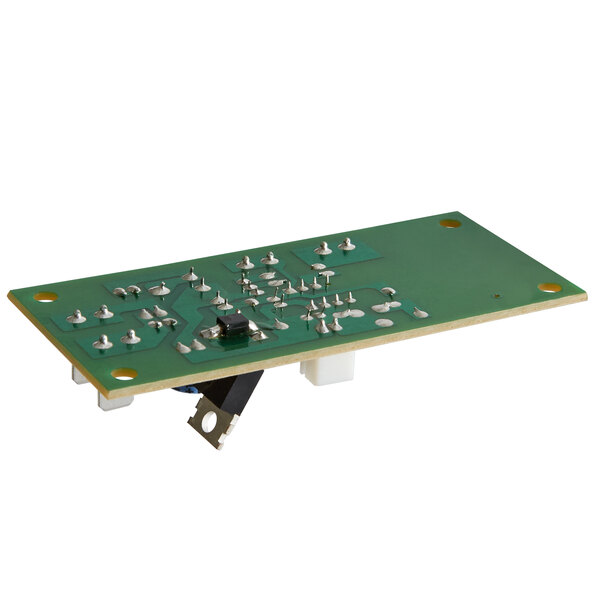 A close-up of a green Avantco control board circuit board with small metal components.