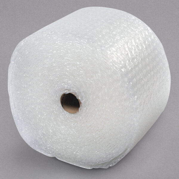 A roll of Sealed Air bubble wrap on a gray surface.