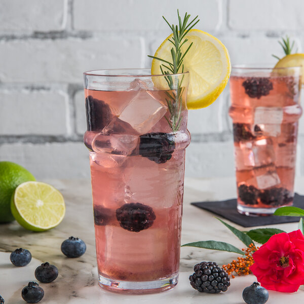 Two Libbey Tritan plastic stackable cooler glasses with pink drinks, blackberries, and rosemary.