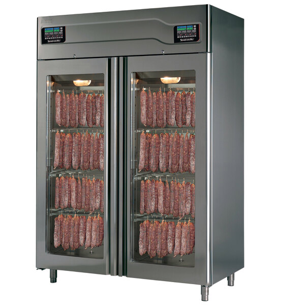 A Stagionello stainless steel meat curing cabinet with glass doors filled with sausages.