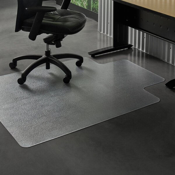 A black office chair with wheels on a ES Robbins Clear Vinyl hard floor chair mat with a lip.