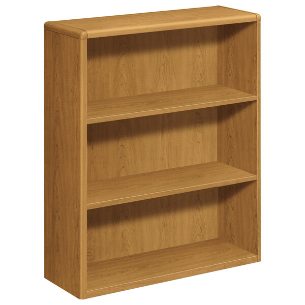 A HON wooden bookcase with three shelves.