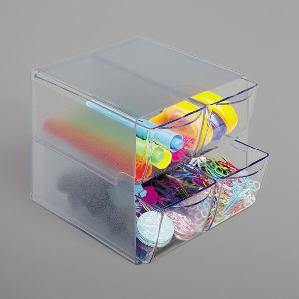 A clear plastic container with a few drawers inside.