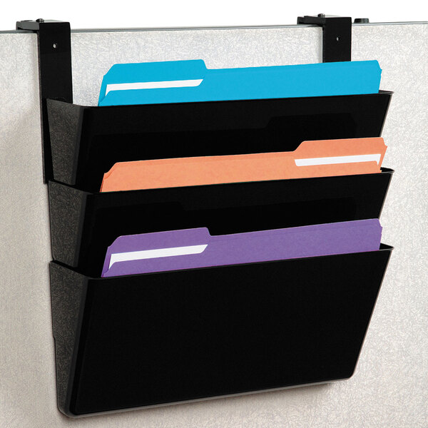 A black Deflecto file holder with three pockets on a wall.