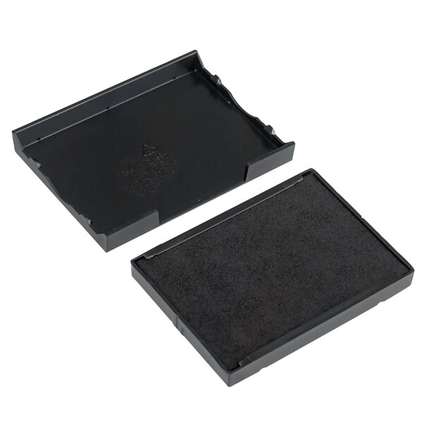 Two black rectangular trays with black surfaces.