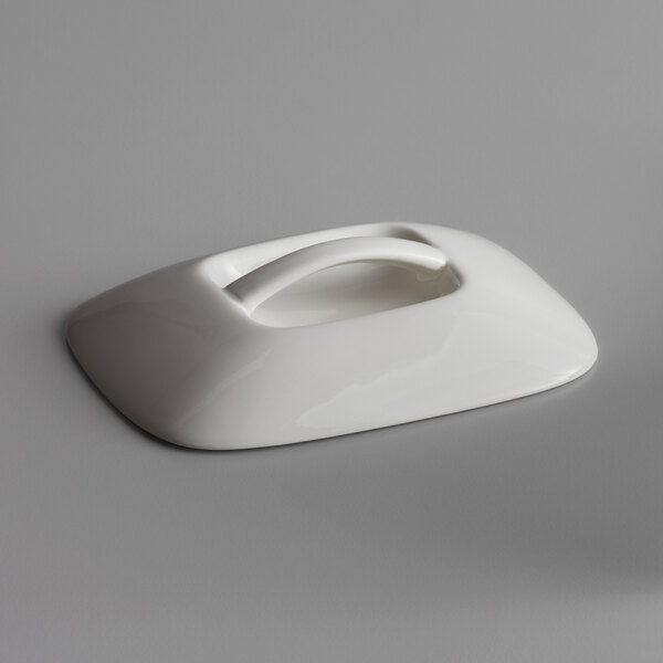 The white porcelain rectangular crock lid with a handle.