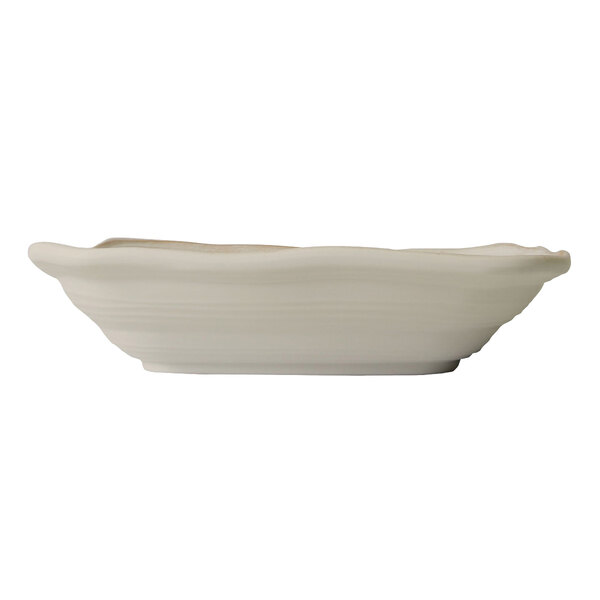 An off white irregular square bowl with a wavy edge.
