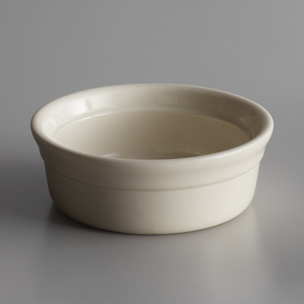 A Libbey Casablanca small white porcelain bowl with a white rim on a gray surface.