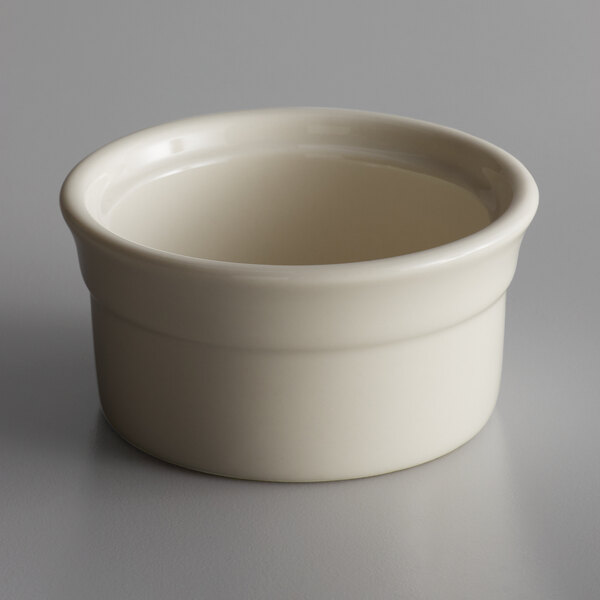 A Libbey white porcelain ramekin on a gray surface.