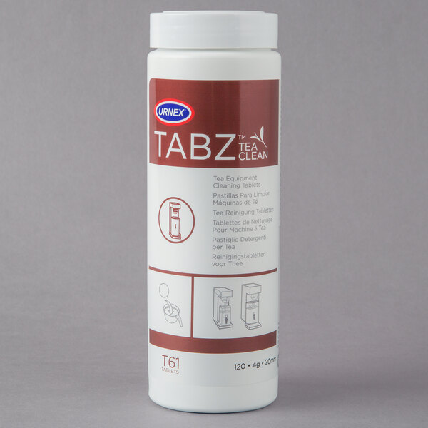 A white container of Urnex Tabz Tea Equipment Cleaner Tablets with a red and white label.