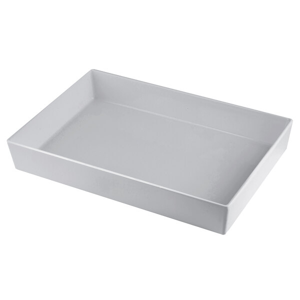 A natural finish rectangular cast aluminum bowl with straight sides on a white background.