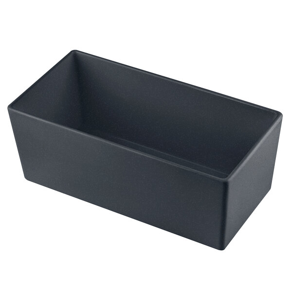 A Tablecraft black rectangular cast aluminum bowl with blue speckles on a white counter.