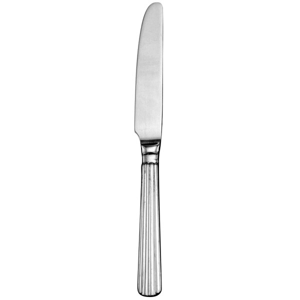 A close-up of a Walco stainless steel dinner knife with a long handle.