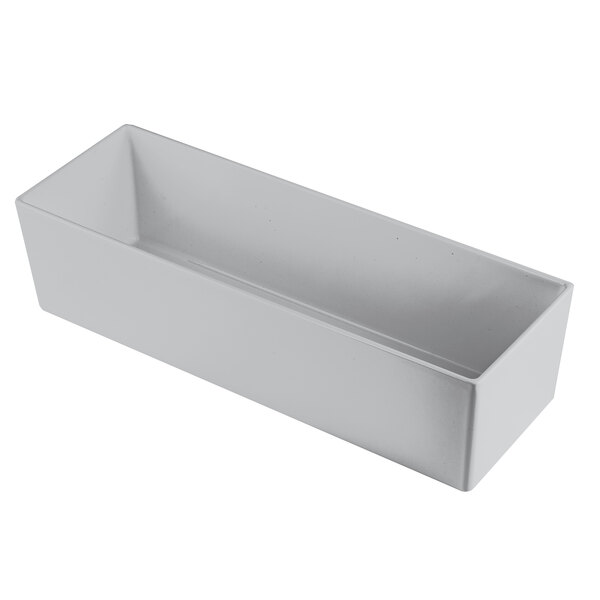 A natural finish cast aluminum long rectangular bowl with straight sides.