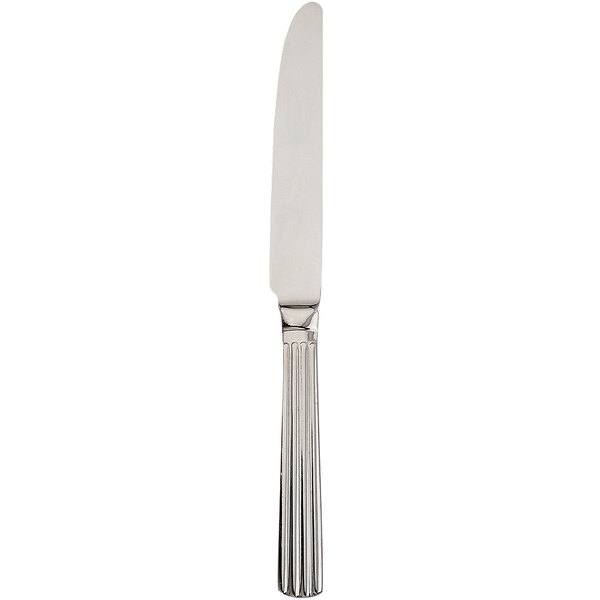 A close-up of a Walco stainless steel table knife with a long silver handle.