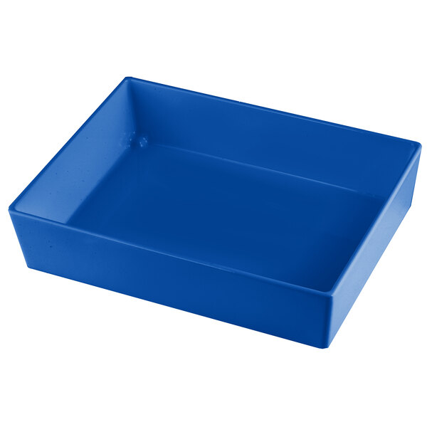 A Tablecraft cobalt blue cast aluminum rectangular bowl on a white counter.